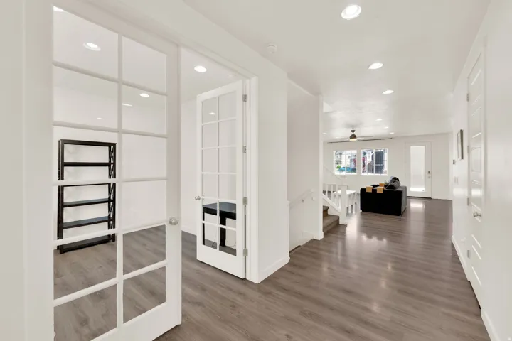 Hall with recessed lighting, dark wood-type flooring, and french doors