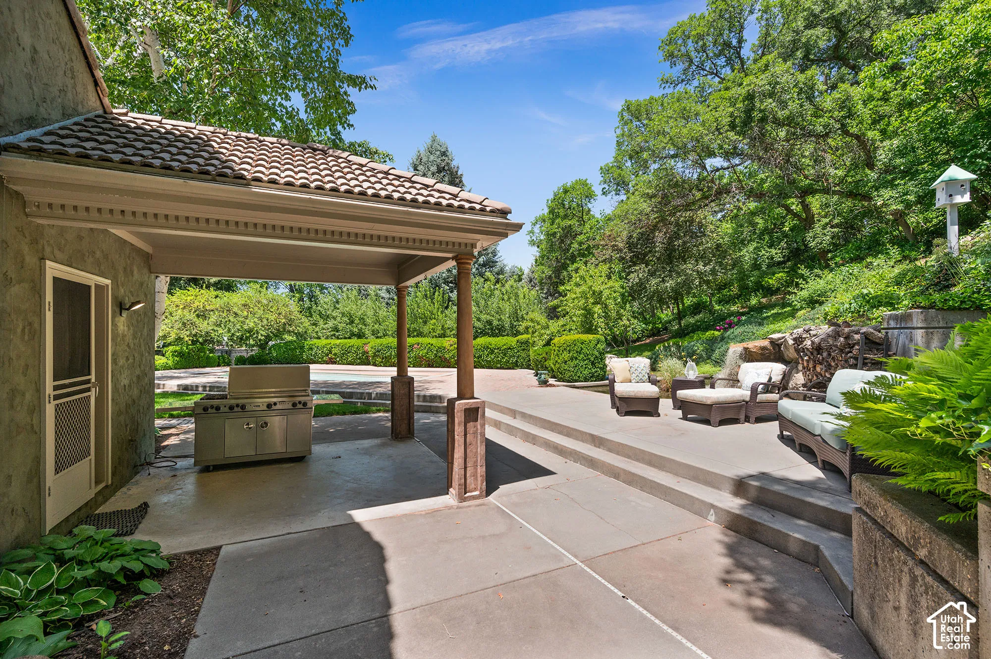 Back patio with grill, and furniture.
