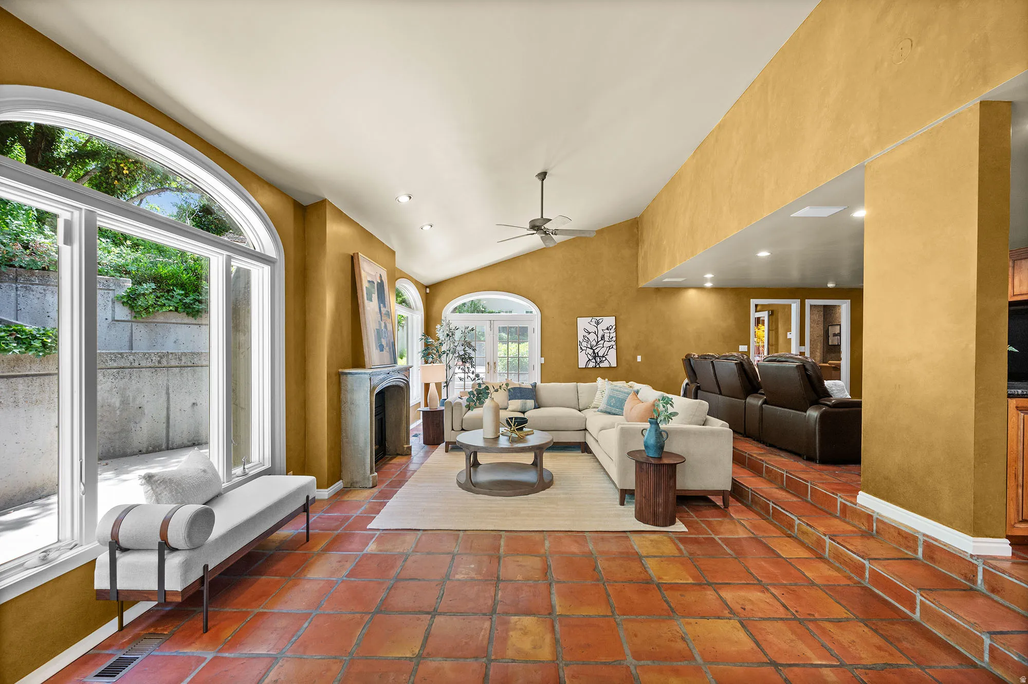 Family room located in the back area of the home, next to theater area, fireplace, patio doors to the exterior.