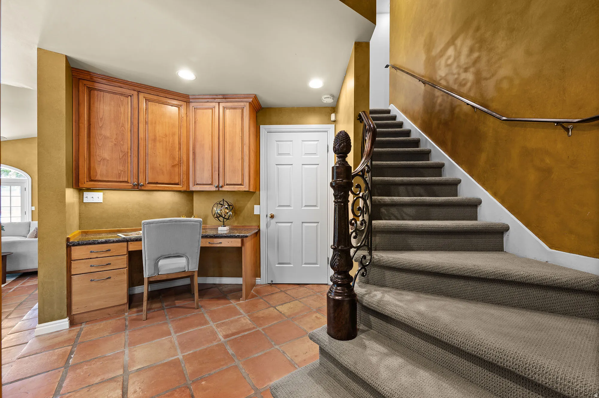 Home office featuring built in study area and extra storage off the kitchen.  2nd staircase too.