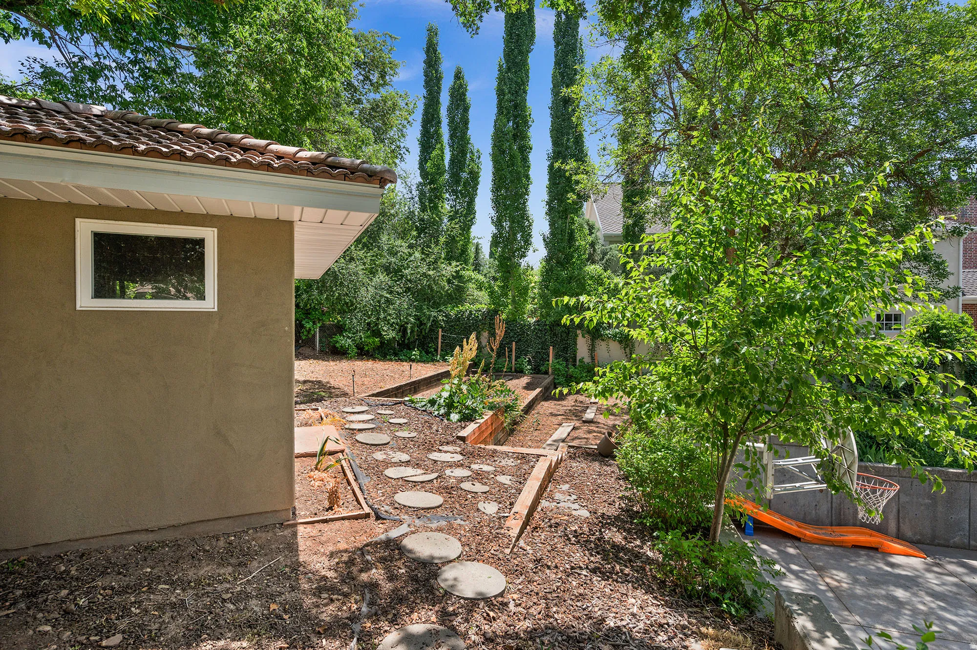 Fenced yard featuring a vegetable garden