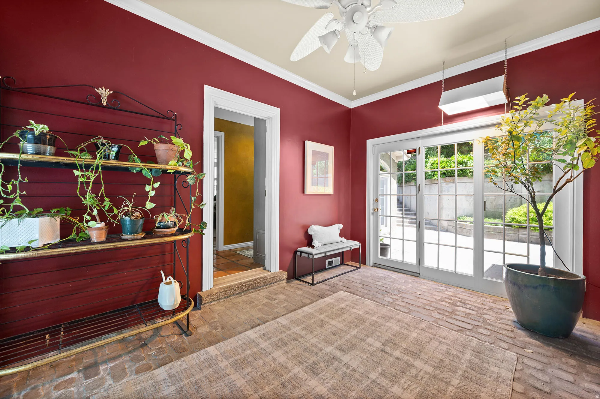 Entrance from the garage, sun room for plants and doors on both sides.  Joins both house and garage nicely.