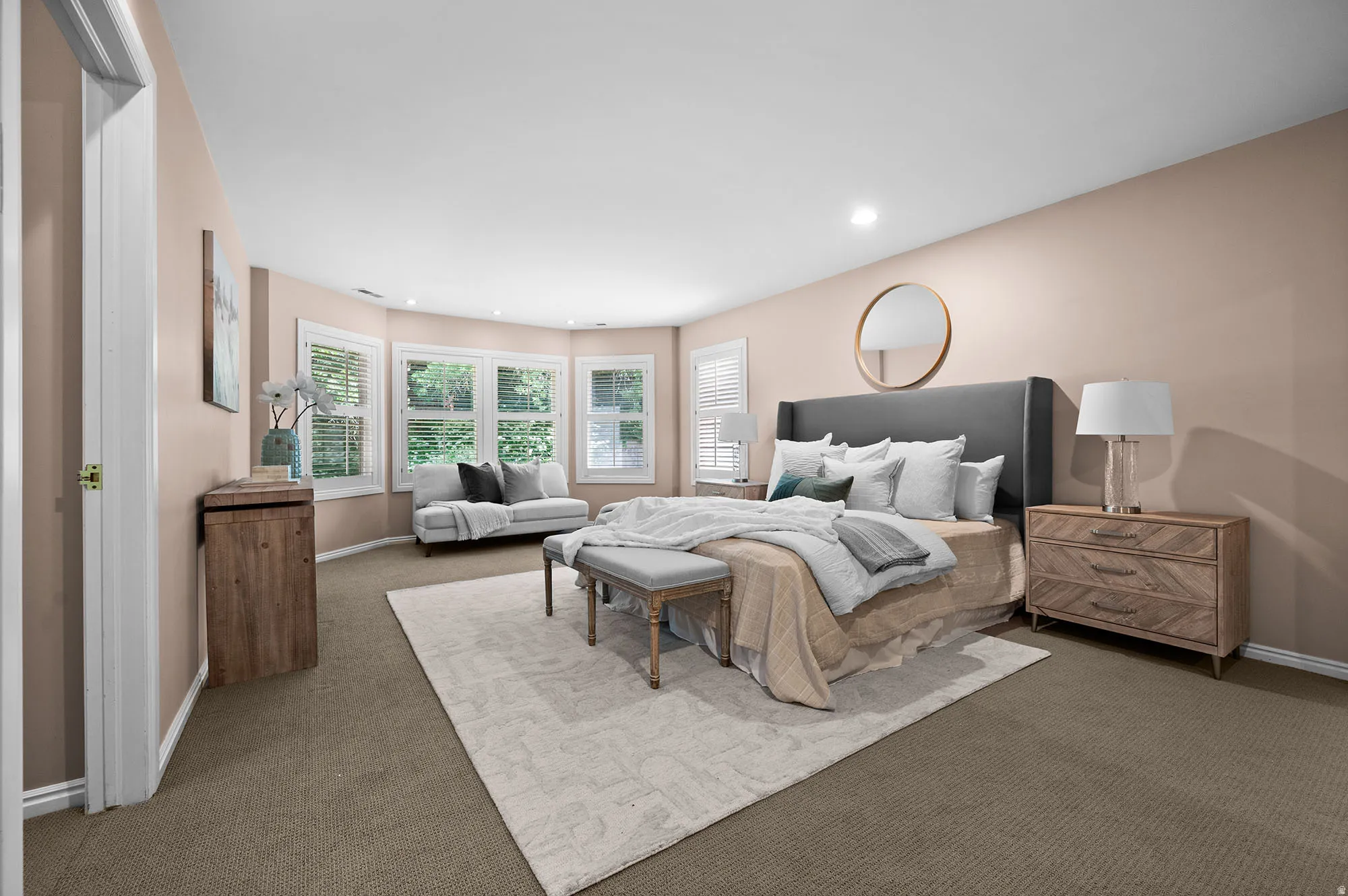 Large primary bedroom, with attached family room, TV.   Views of greenery and back yard.