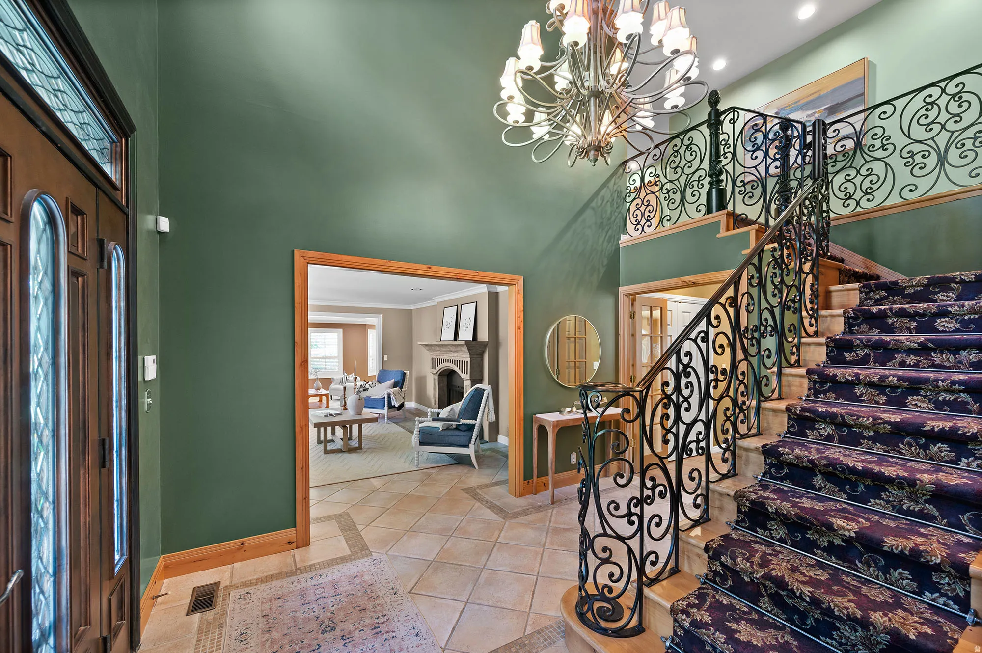 Entryway and ornate staircase, view of LR.  There are 2 staircases to the upper level, the second one is off the kitchen.