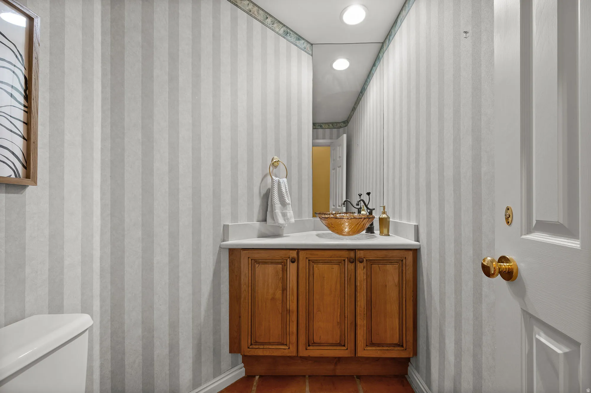 Half bath in hallway off the kitchen.