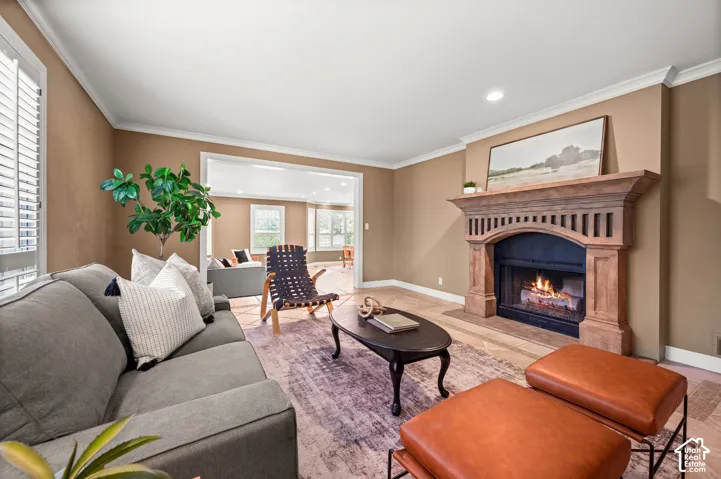 Living area with a carved wood fireplace mantel, an arched firebox, and tile hearth
