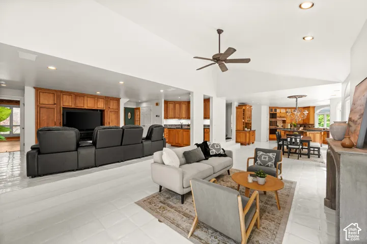 Open-concept family living space & theater area featuring a vaulted ceilings.