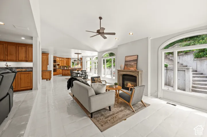 Vaulted ceilings complement the light-toned tile flooring throughout this open living space