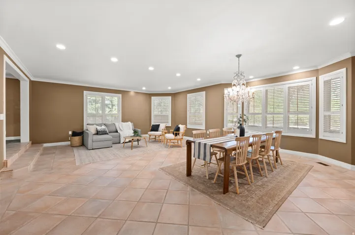Dining room with living area, plenty of windows.