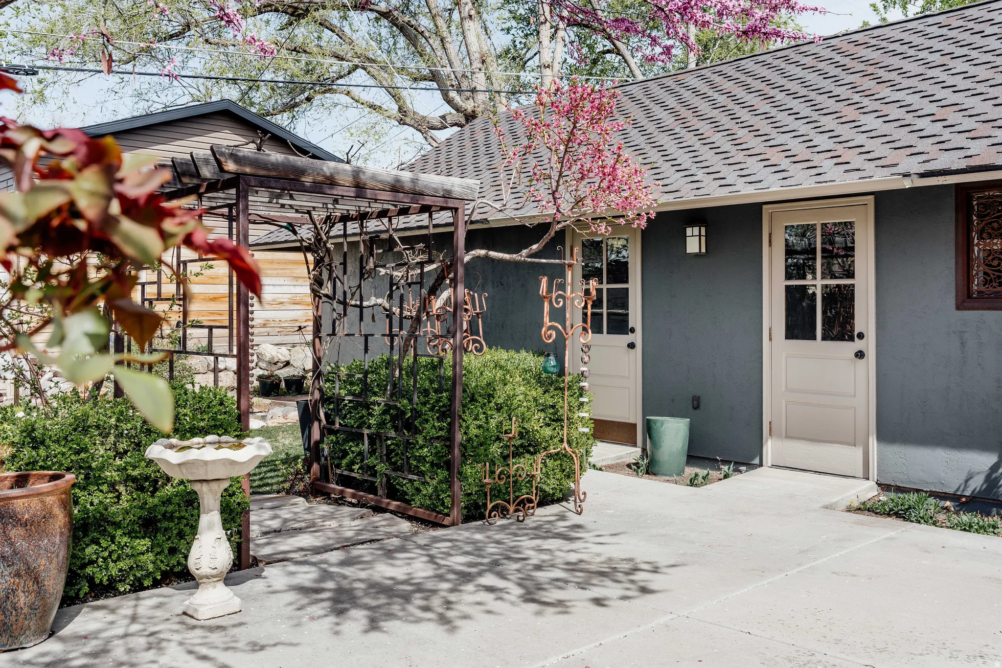 Entrance to property featuring stucco siding and roof with shingles