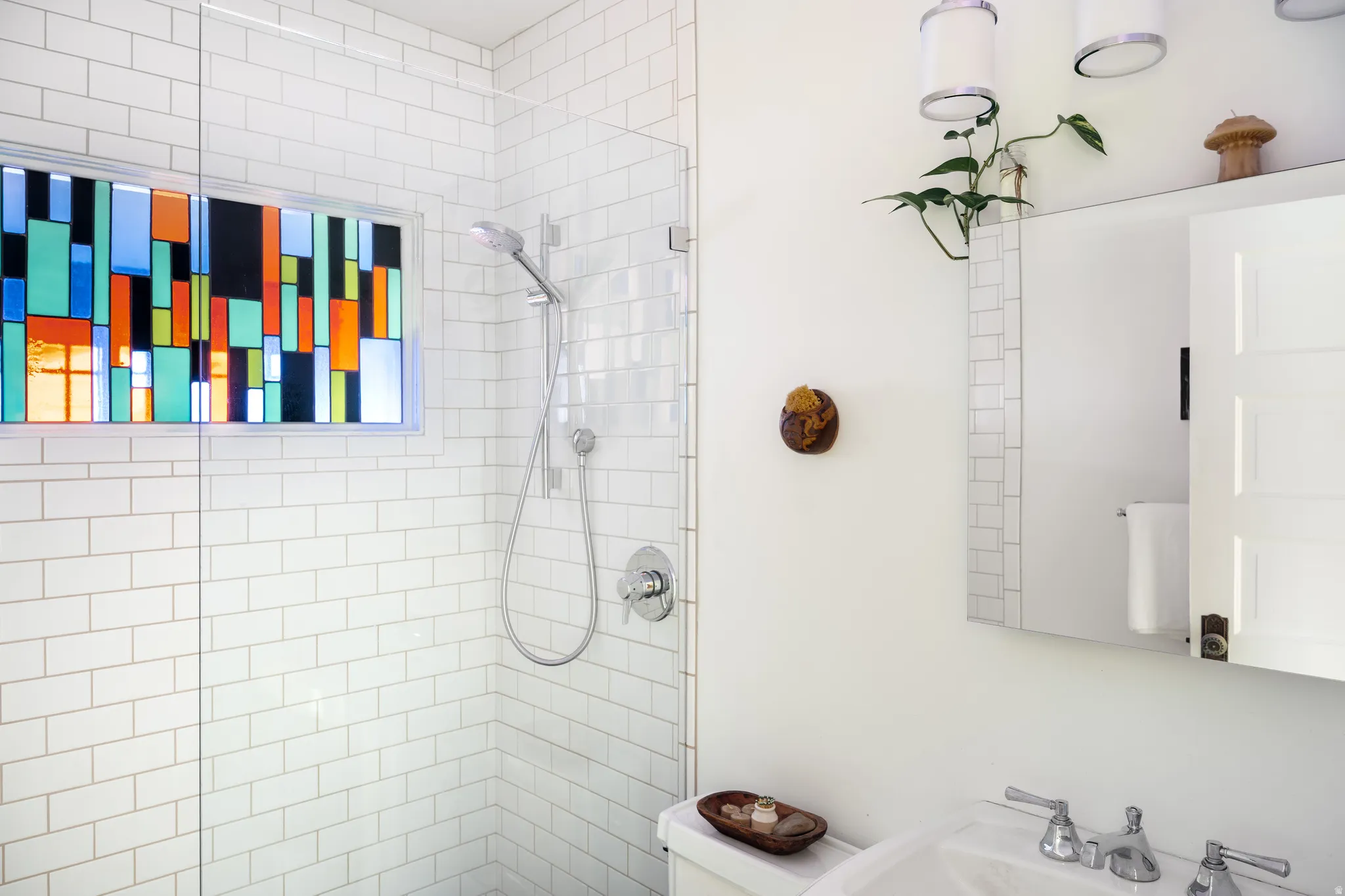 Full bath featuring toilet and a tile shower