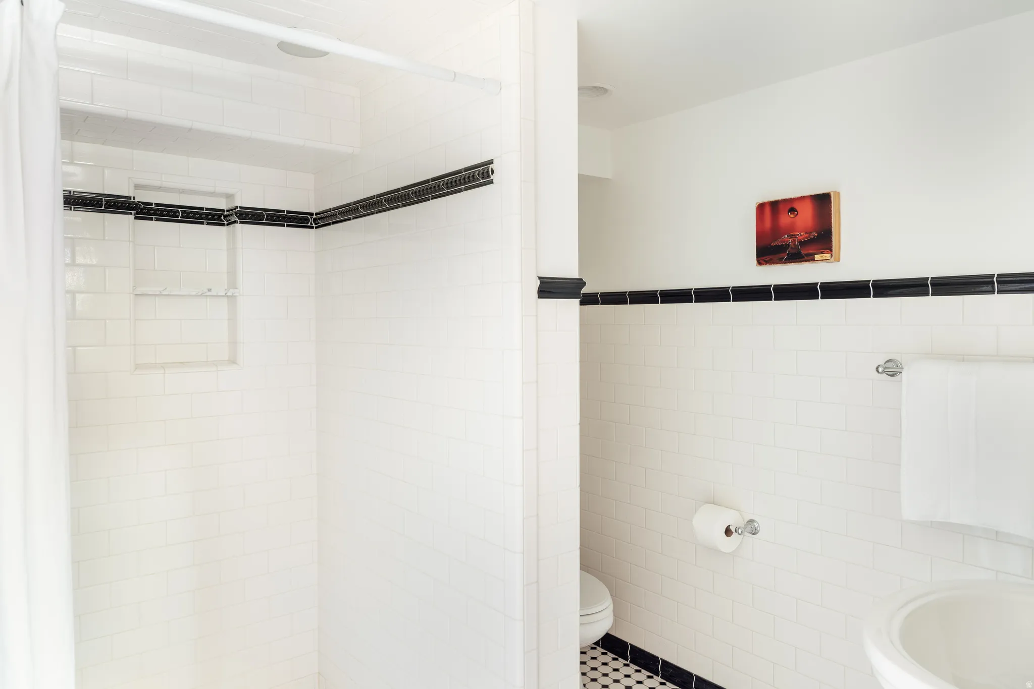 Bathroom featuring tile walls, a shower stall, wainscoting, and tile patterned floors
