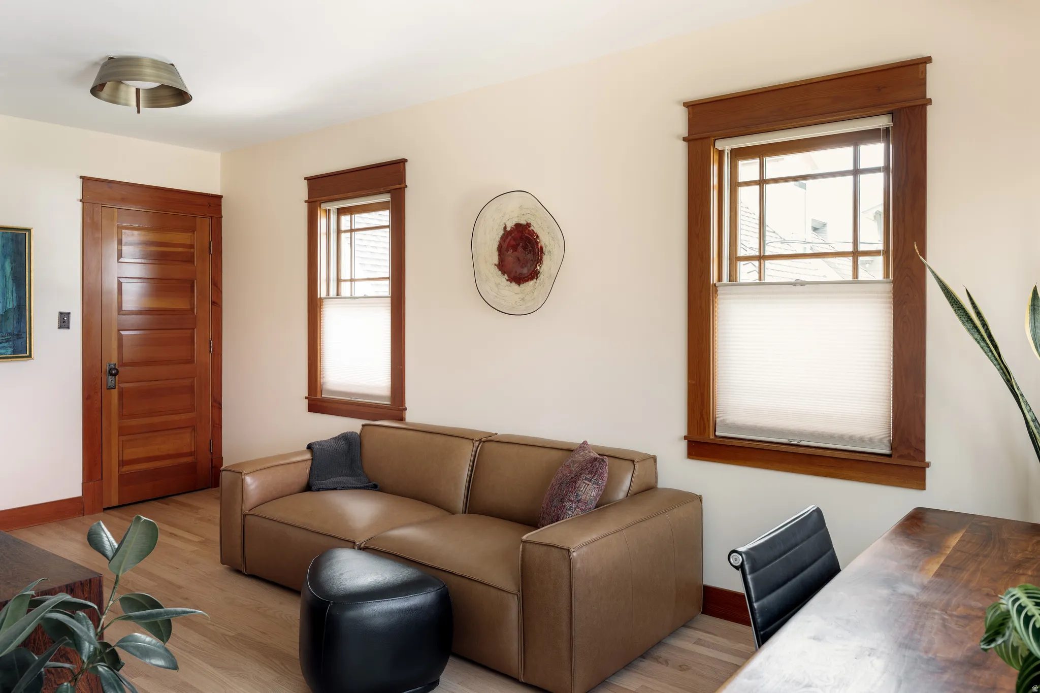 Living area featuring wood finished floors and an office area