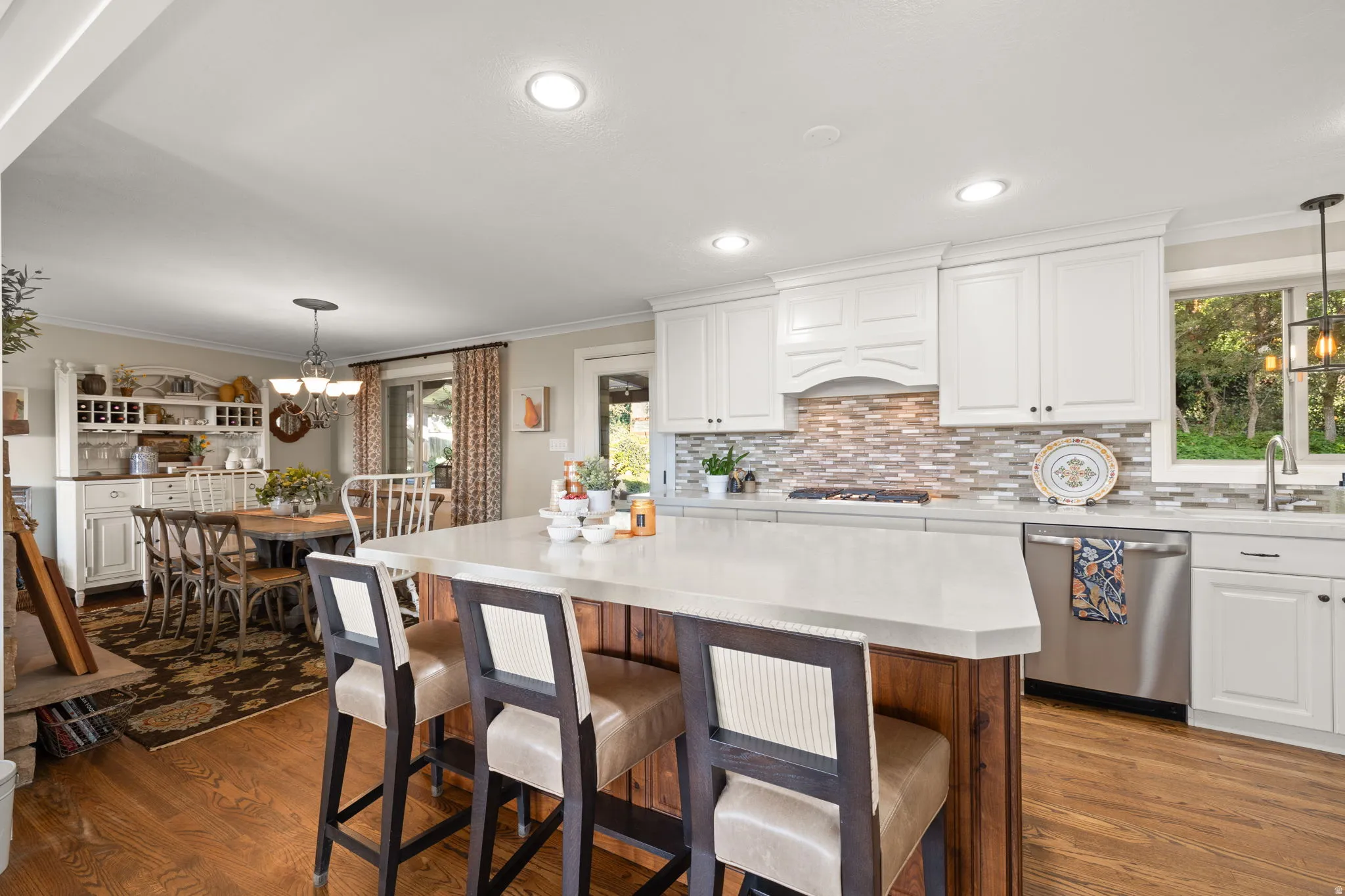 Kitchen featuring gas cooktop, double ovens, quartz countertops and updated cabinetry