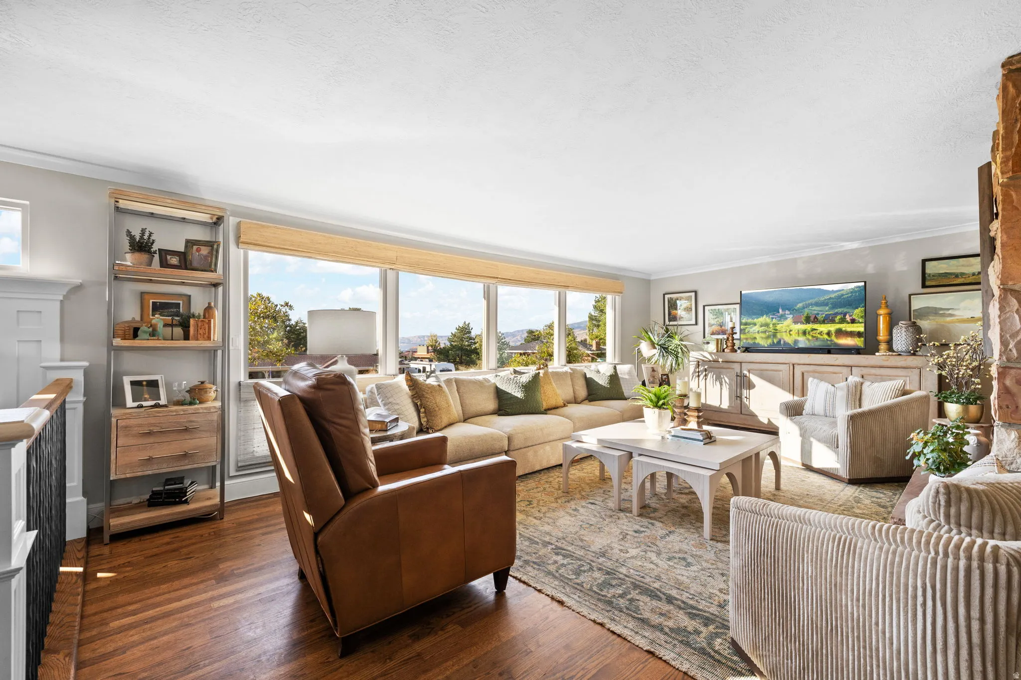 Living room featuring hardwood flooring, wood burning fireplace and views of Salt Lake valley