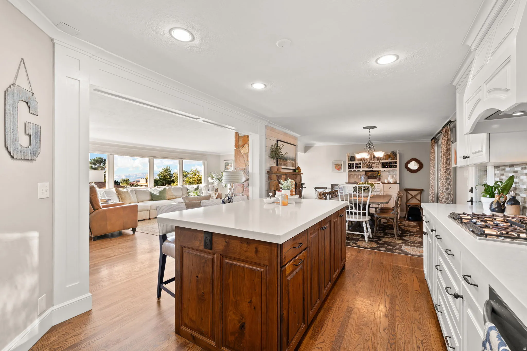 Kitchen featuring gas cooktop, double ovens, quartz countertops and updated cabinetry