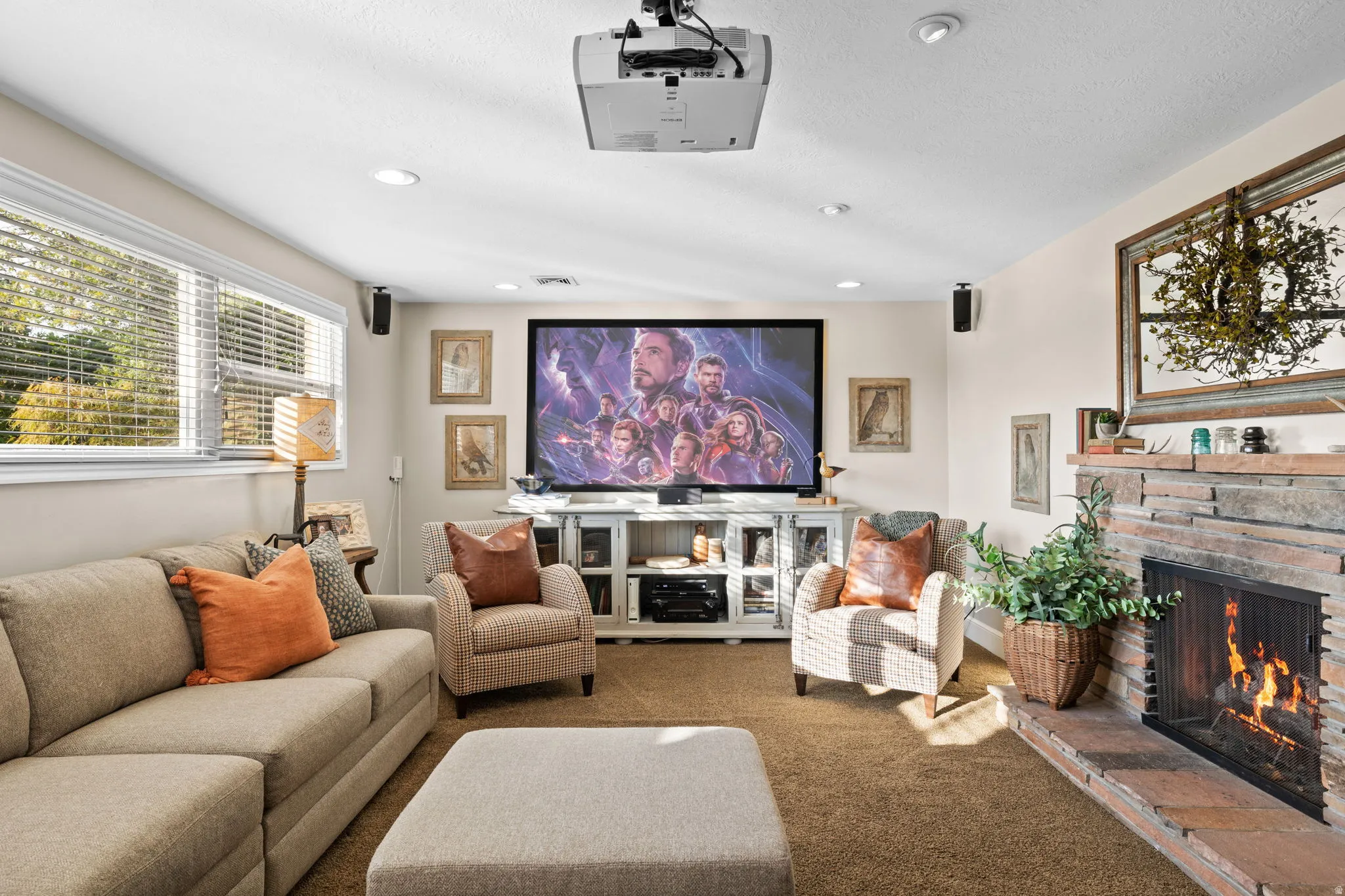 Lower level living room with expanded windows, gas fireplace and home theatre projector
