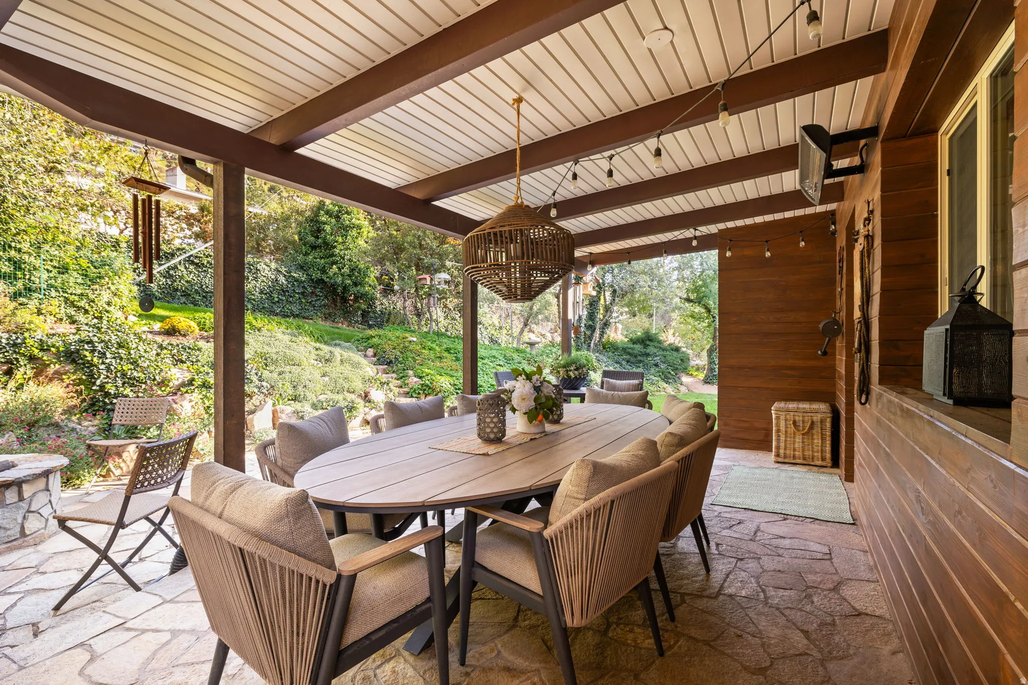 Backyard patio with hardwired heaters, firepit, dining space and kitchenette
