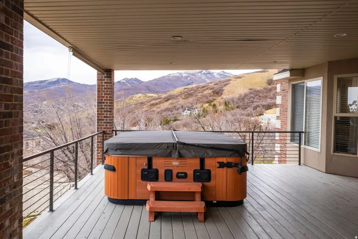 Deck featuring a hot tub and a mountain view