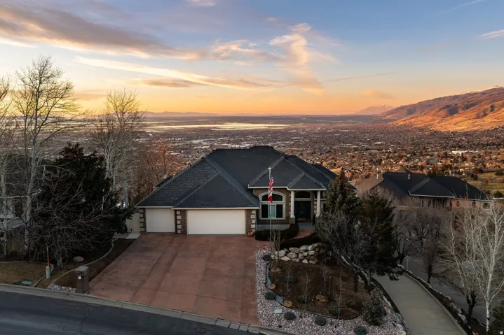 View of front of house with a garage, driveway, and a mountain view