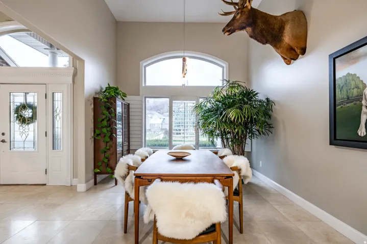 Dining space with a high ceiling and light tile patterned flooring