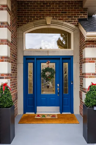 Doorway to property with brick siding