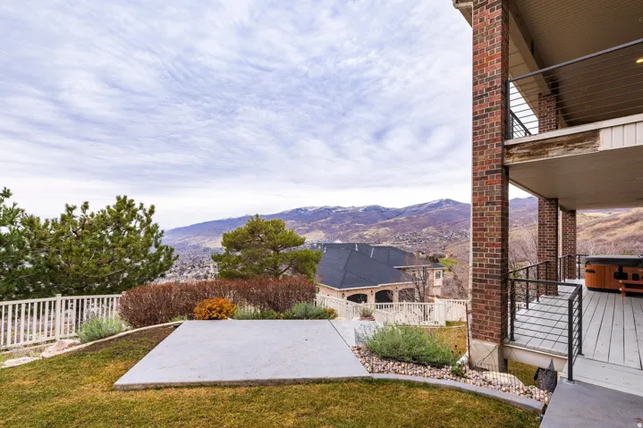View of yard with a mountain view, a patio area, and a balcony