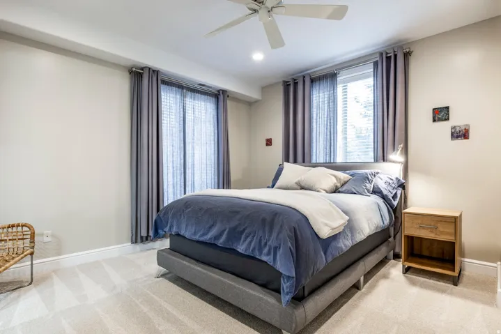 Bedroom with light carpet, a ceiling fan, and recessed lighting