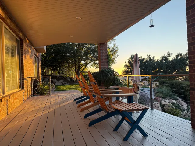Covered deck with painted wood-finish flooring, brick exterior, recessed lighting, and cable railing system