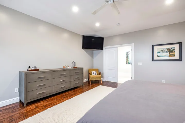 Bedroom featuring dark wood-style flooring, ceiling fan, and recessed lighting