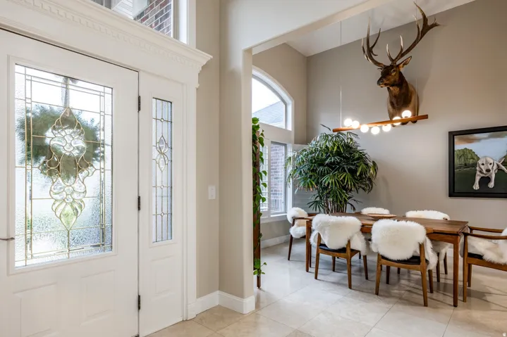 Entryway featuring a high ceiling and light tile patterned flooring