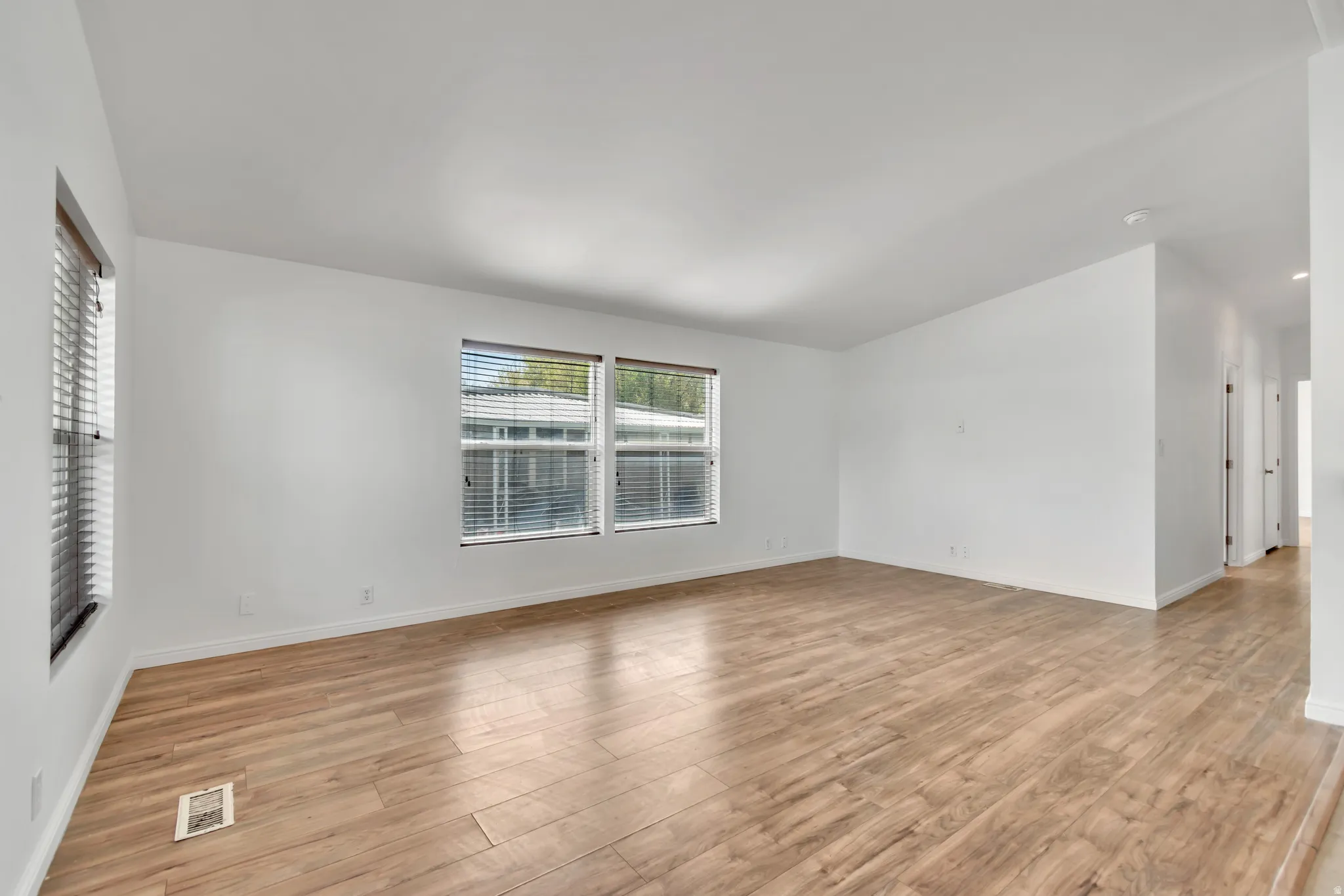Empty room with light wood-style floors and baseboards