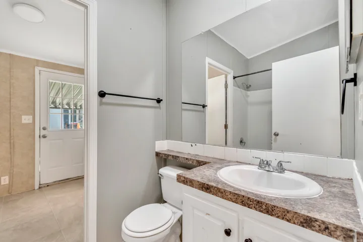 Full bath featuring vanity, a shower, and light tile patterned floors