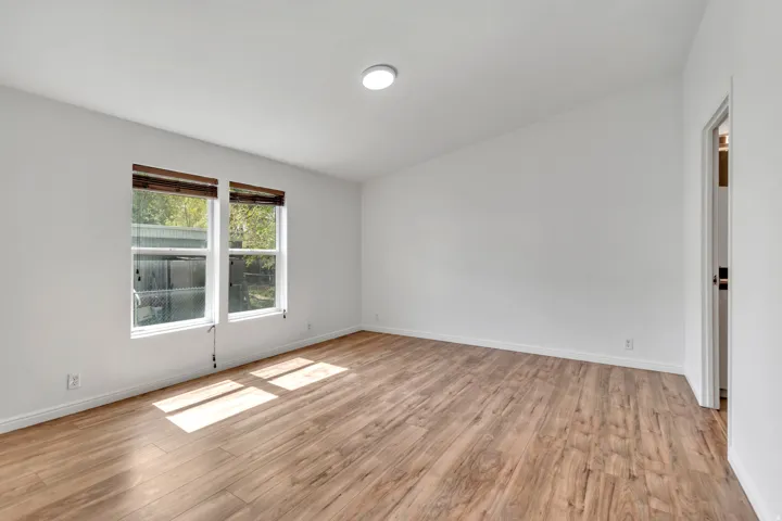 Empty room with light wood-style floors and baseboards