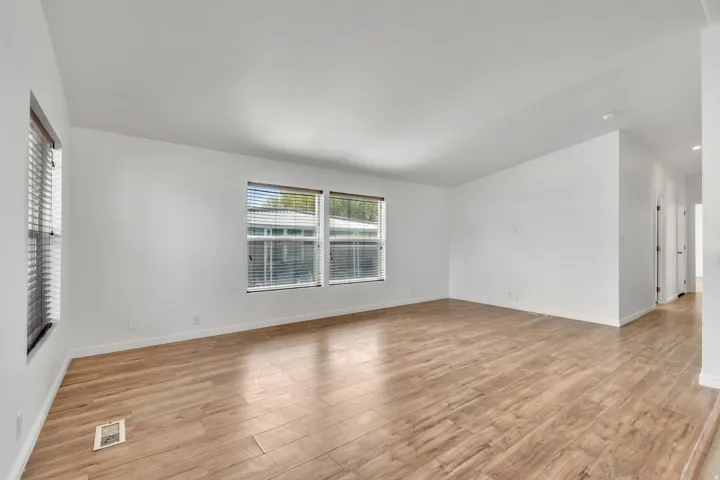 Empty room with light wood-style floors and baseboards