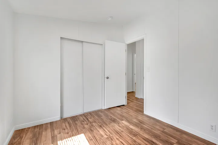 Unfurnished bedroom with light wood-type flooring and a closet