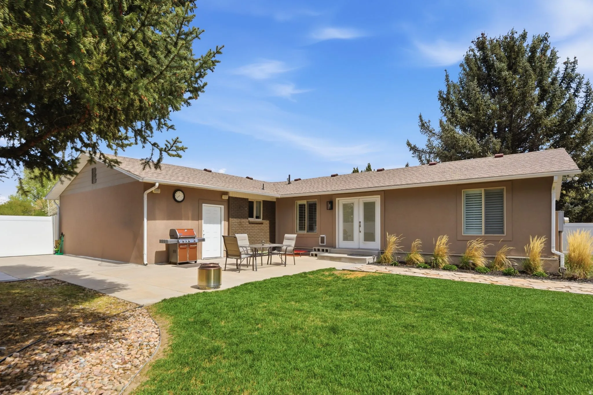 Back of house featuring french doors, a patio area, a shingled roof, and stucco siding