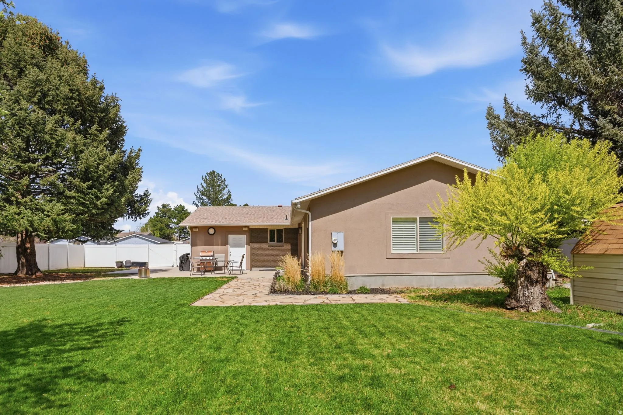 Rear view of house with stucco siding