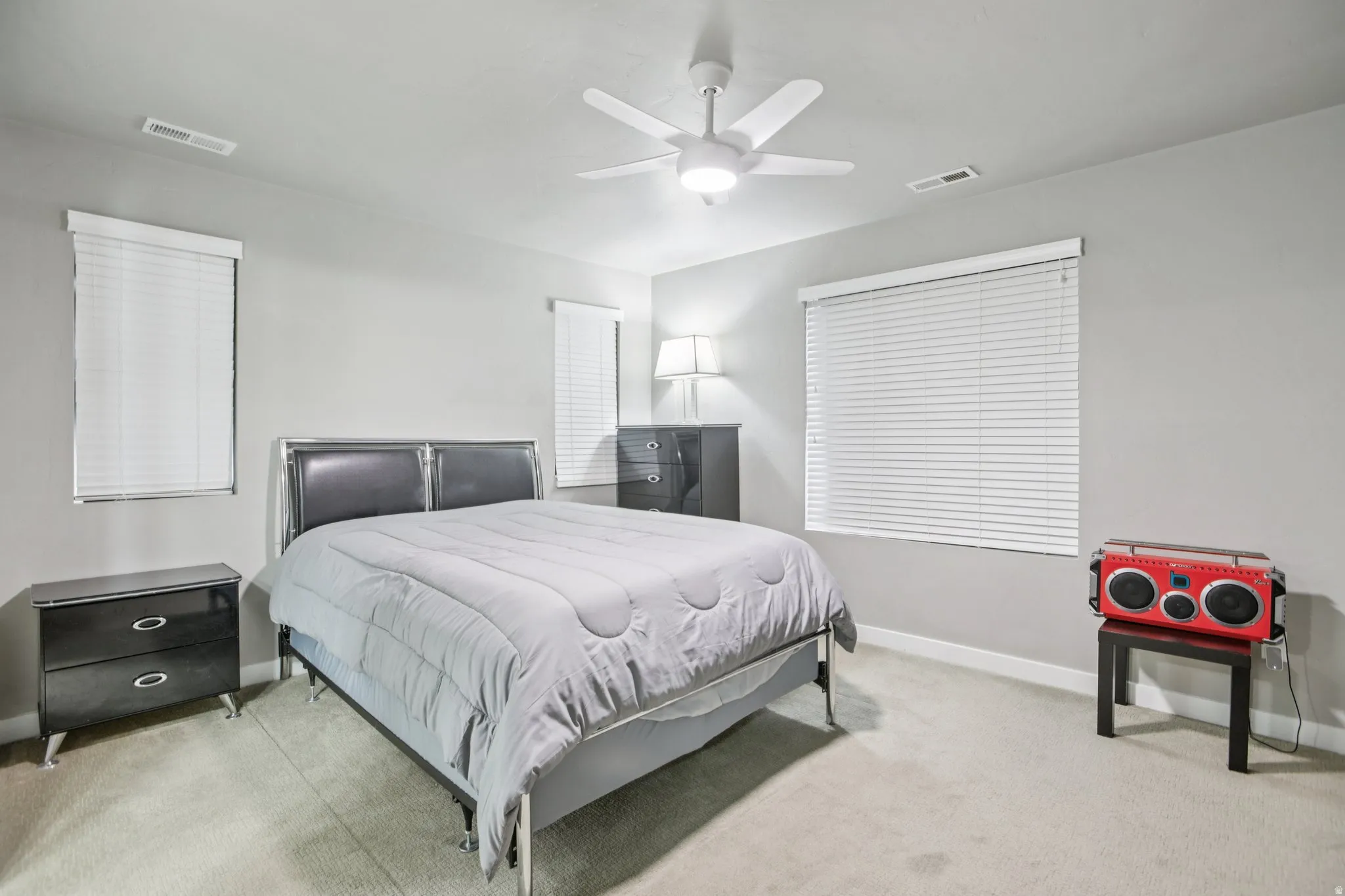 Bedroom featuring light carpet and ceiling fan
