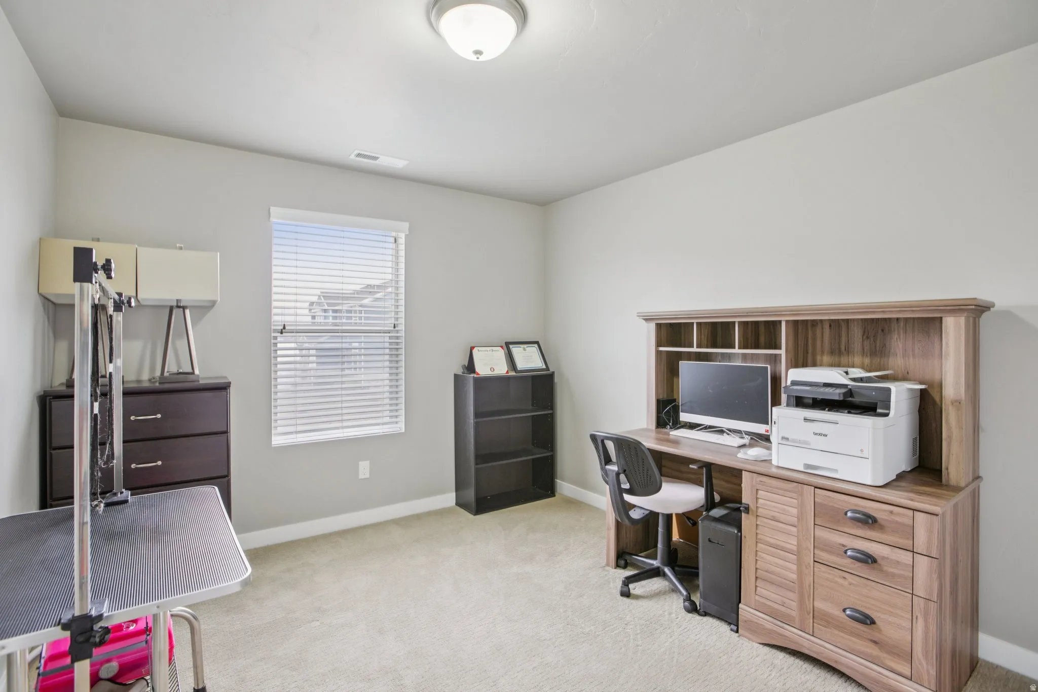 Office featuring light colored carpet and baseboards
