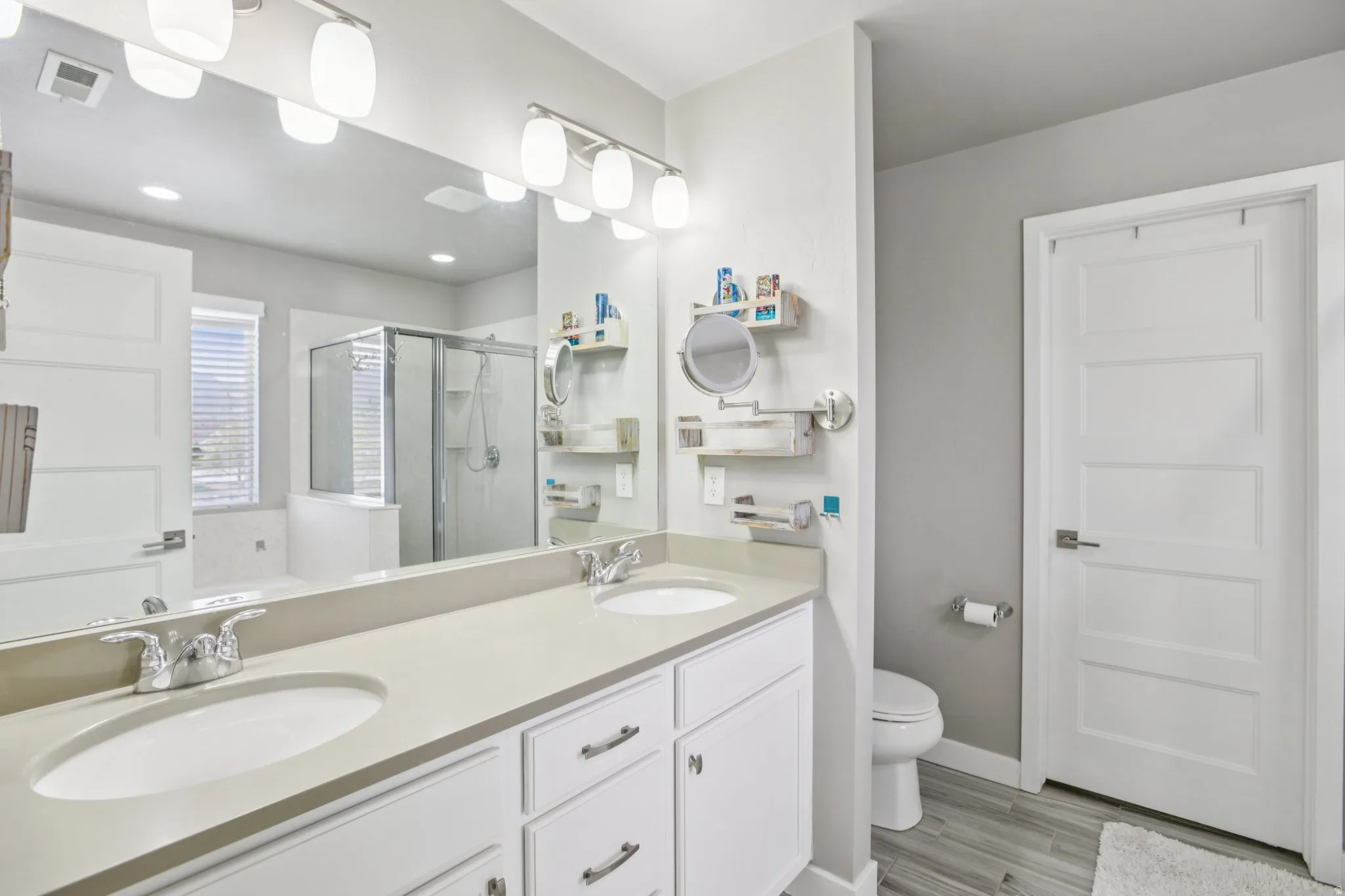 Master Full bath featuring double vanity, a shower stall, and a bath