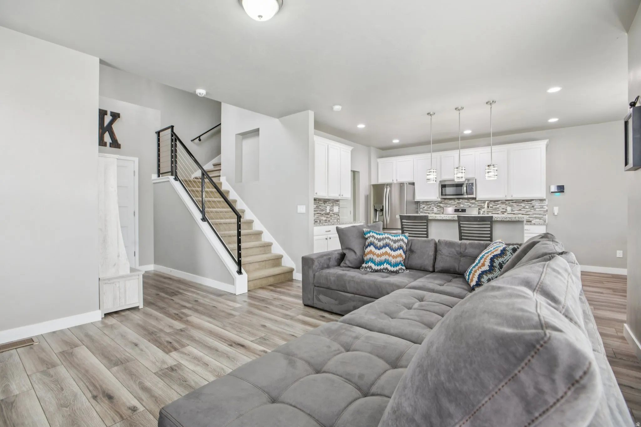 Living room featuring light wood-type flooring and recessed lighting