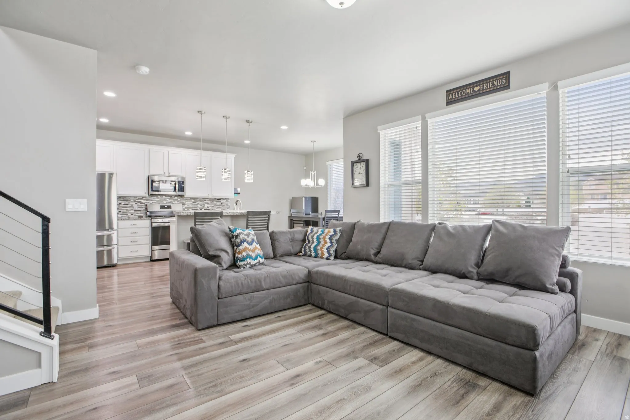Living room featuring light wood-style flooring and a chandelier