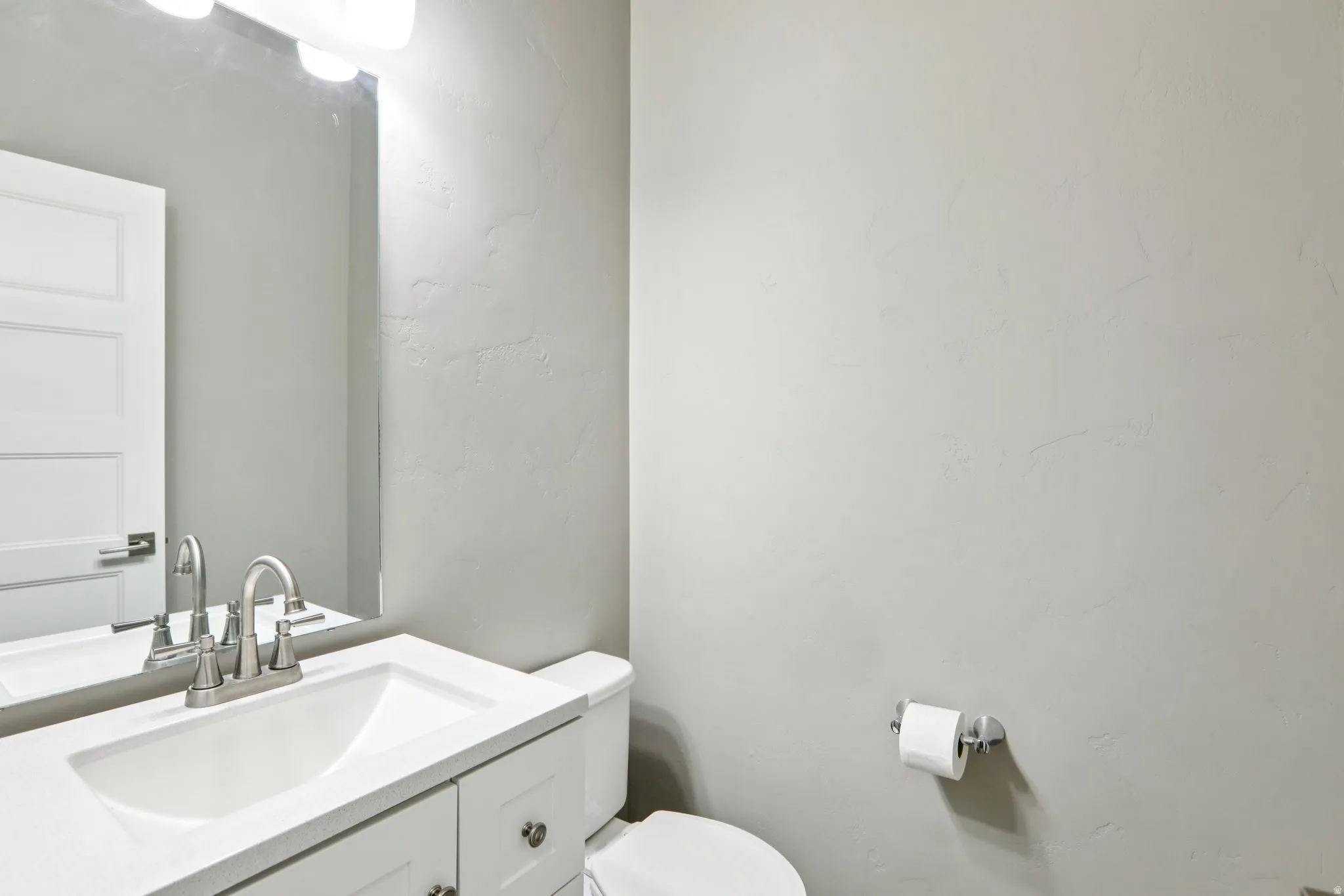 Half bath with vanity and toilet on main floor