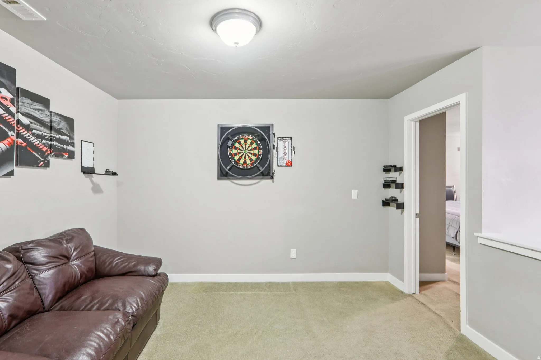 Den room with baseboards and light carpet