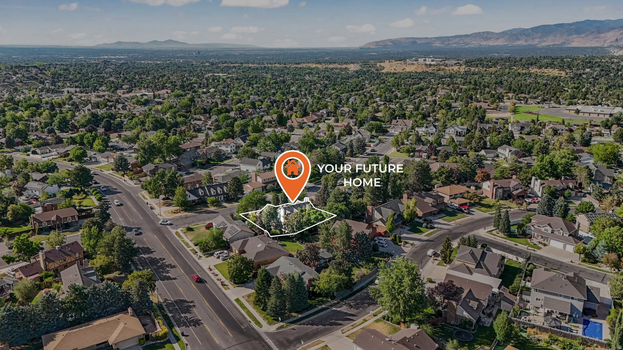 Aerial perspective of suburban area with property parcel outlined and a mountain backdrop