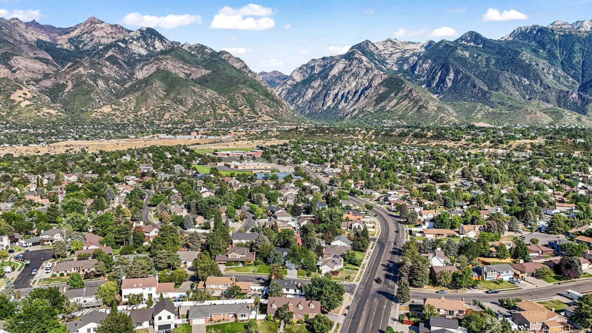 Aerial perspective of suburban area featuring a mountainous background