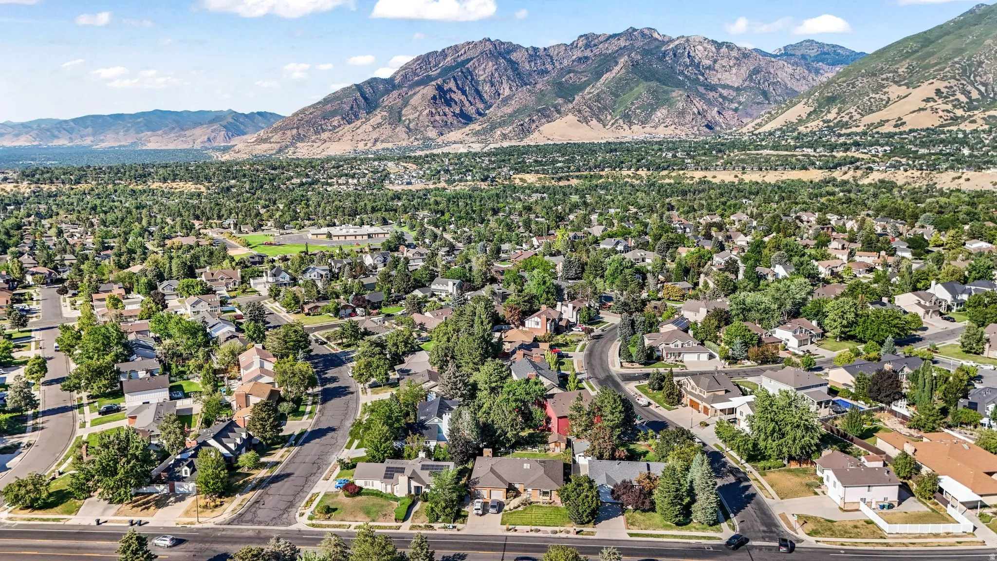 Aerial perspective of suburban area featuring a mountain backdrop