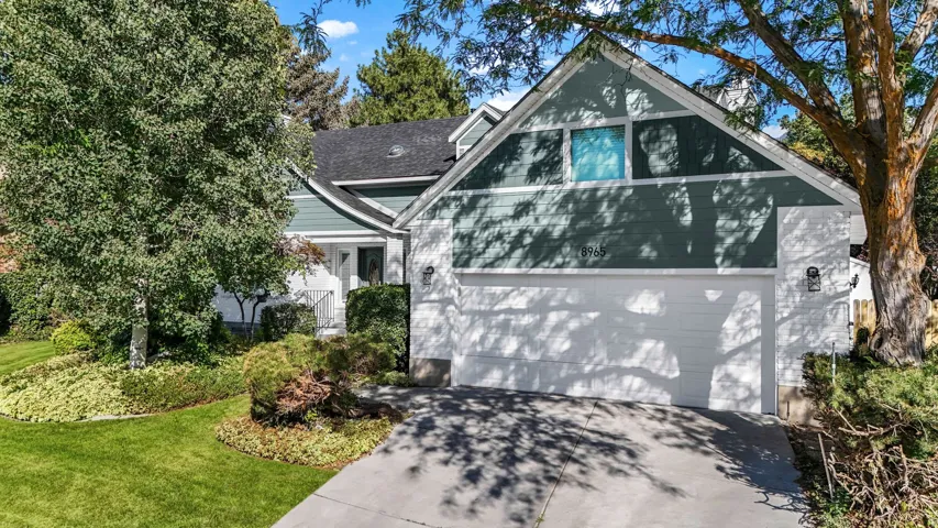 View of front of house with driveway and a front lawn