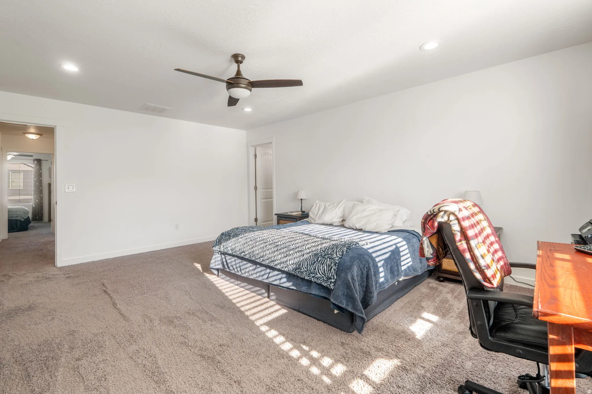 Carpeted bedroom featuring recessed lighting, a ceiling fan, and a desk